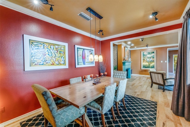 5713 Pershing Ave, Fort Worth, TX 76107 - dining space featuring baseboards, ornamental molding, wood finished floors, and visible vents