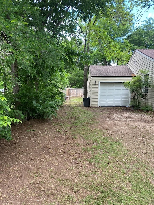 405 Davis St, Weatherford, TX 76086 - view of yard with a garage, fence, and dirt driveway