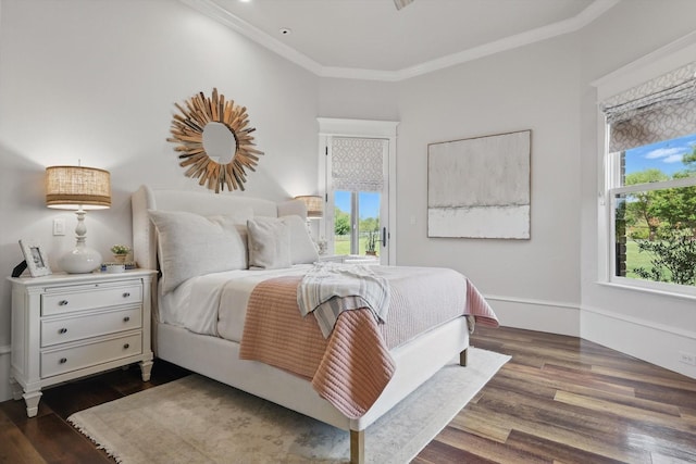 bedroom featuring access to outside, dark wood finished floors, multiple windows, and ornamental molding