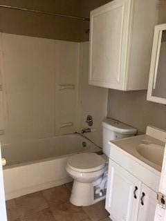 bathroom with bathing tub / shower combination, vanity, tile patterned flooring, and toilet