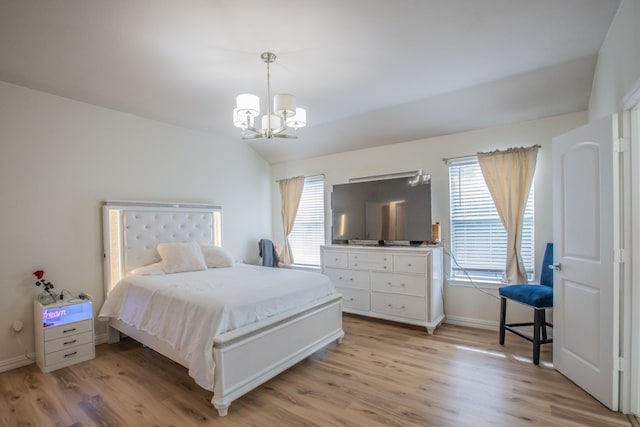 bedroom with baseboards, a notable chandelier, and light wood-style floors