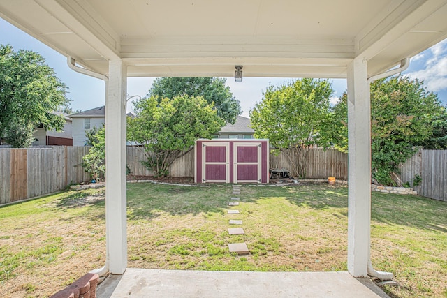 view of yard featuring a fenced backyard, an outbuilding, and a shed