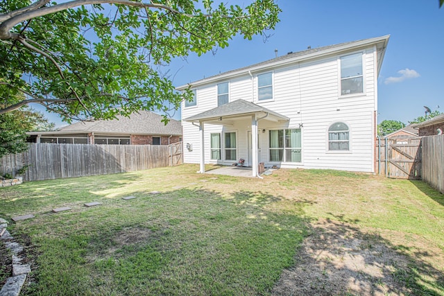rear view of house featuring a fenced backyard, a gate, a patio, and a lawn