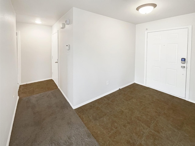 spare room with baseboards
