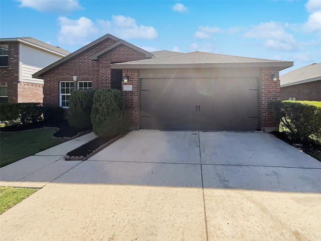 view of front of house featuring an attached garage, brick siding, and concrete driveway