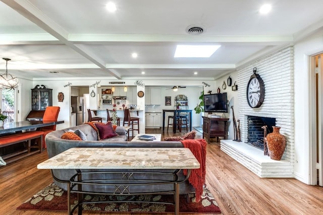 717 Cliffside Dr, Richardson, TX 75080 - living room featuring wood finished floors, beam ceiling, a brick fireplace, coffered ceiling, and ceiling fan