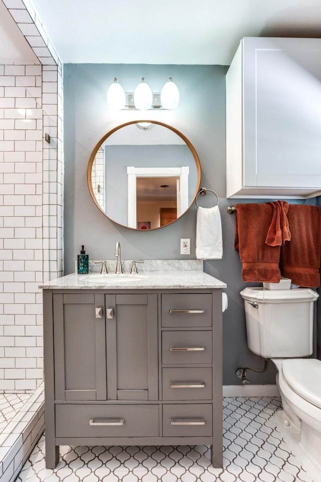 717 Cliffside Dr, Richardson, TX 75080 - full bathroom with toilet, a stall shower, vanity, and tile patterned floors