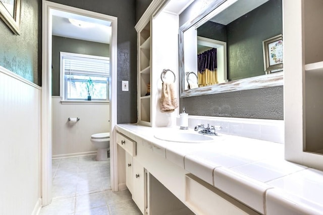 717 Cliffside Dr, Richardson, TX 75080 - bathroom with toilet, vanity, and tile patterned floors