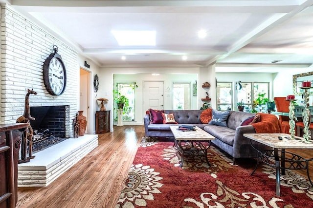 717 Cliffside Dr, Richardson, TX 75080 - living room with wood finished floors, healthy amount of natural light, a fireplace, and beam ceiling