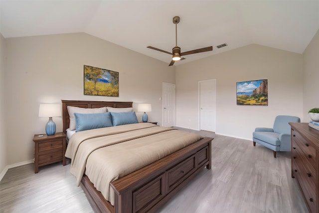 bedroom with lofted ceiling, visible vents, and light wood-style flooring