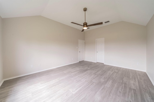 unfurnished room featuring vaulted ceiling, visible vents, a ceiling fan, and wood finished floors