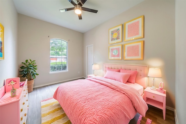 bedroom featuring wood finished floors, baseboards, and ceiling fan