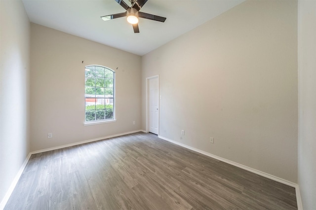 spare room with ceiling fan, baseboards, and wood finished floors