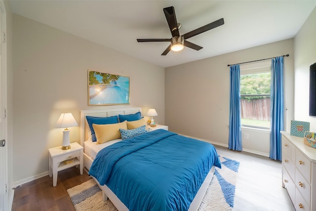 bedroom with baseboards, light wood-style floors, and ceiling fan
