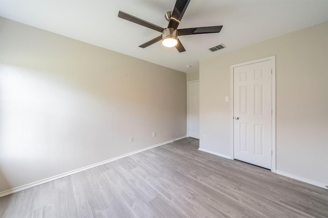 unfurnished bedroom featuring baseboards, a ceiling fan, wood finished floors, and visible vents