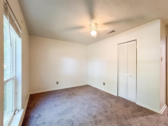 unfurnished bedroom featuring baseboards, carpet flooring, and visible vents