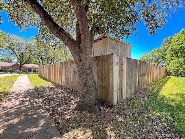 view of side of home featuring fence