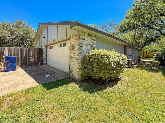 view of side of property featuring fence, a yard, cooling unit, driveway, and brick siding