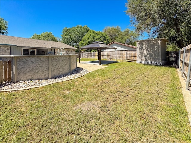 view of yard featuring a fenced backyard, a gazebo, and a carport