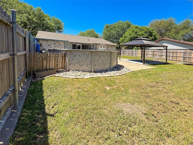 view of yard with a fenced backyard and a gazebo