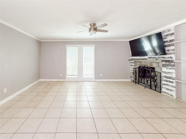 unfurnished living room featuring baseboards, a ceiling fan, crown molding, and a fireplace