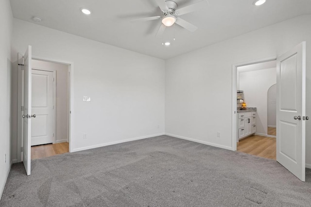 unfurnished bedroom featuring recessed lighting, light colored carpet, and baseboards