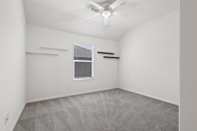 empty room with baseboards, ceiling fan, carpet flooring, and vaulted ceiling