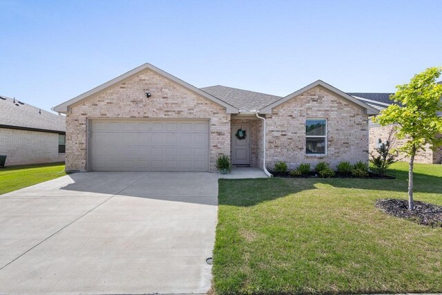 view of front of house with driveway, a shingled roof, an attached garage, brick siding, and a front lawn