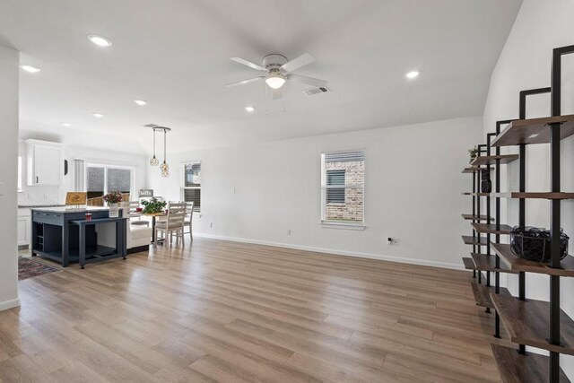 living area with recessed lighting, a ceiling fan, and light wood-style flooring