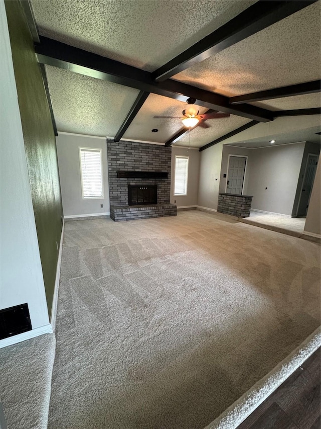 3401 89th St, Lubbock, TX 79423 - unfurnished living room with carpet flooring, healthy amount of natural light, a textured ceiling, a brick fireplace, and a ceiling fan