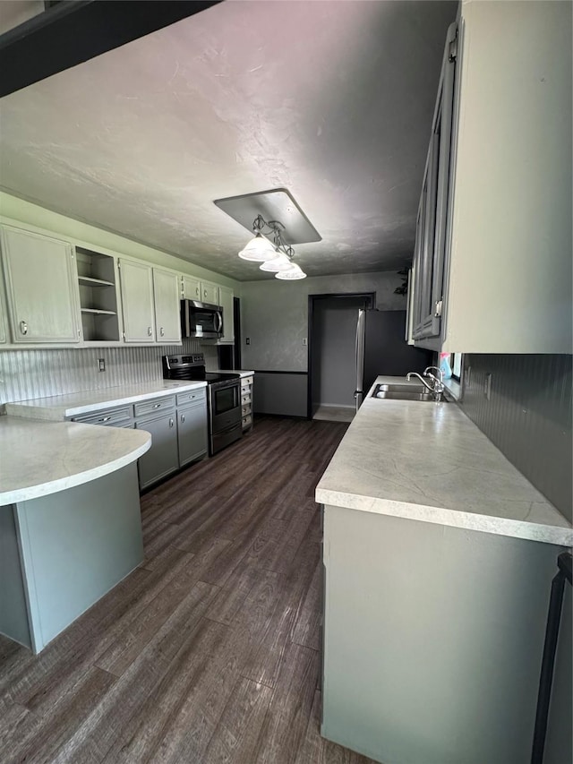 3401 89th St, Lubbock, TX 79423 - kitchen with stainless steel appliances, open shelves, light countertops, and dark wood-style flooring