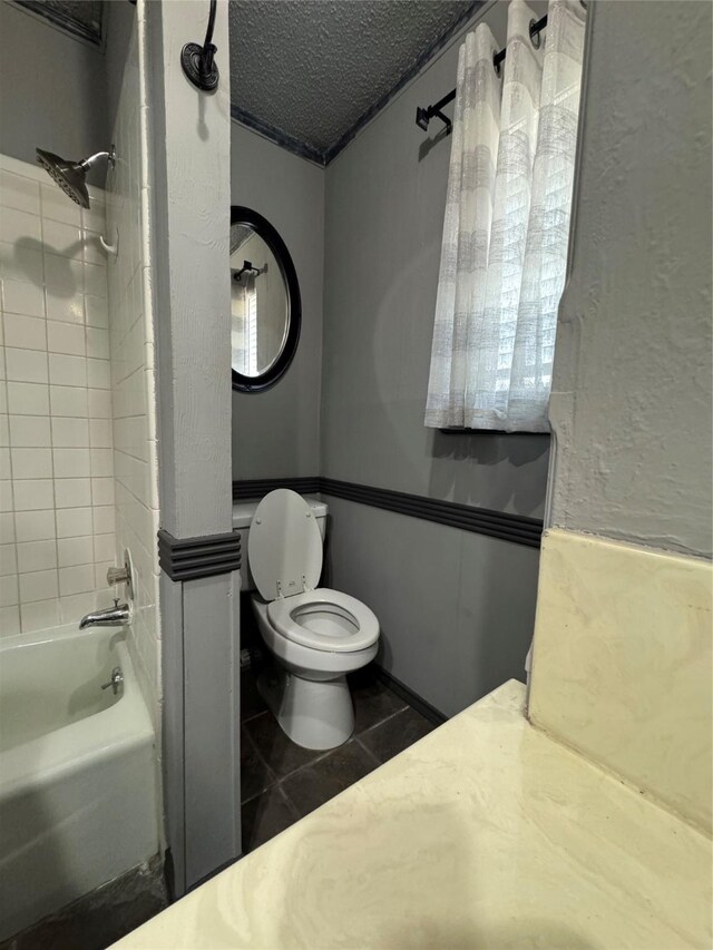 3401 89th St, Lubbock, TX 79423 - full bath featuring shower / bathtub combination, a textured ceiling, and tile patterned floors