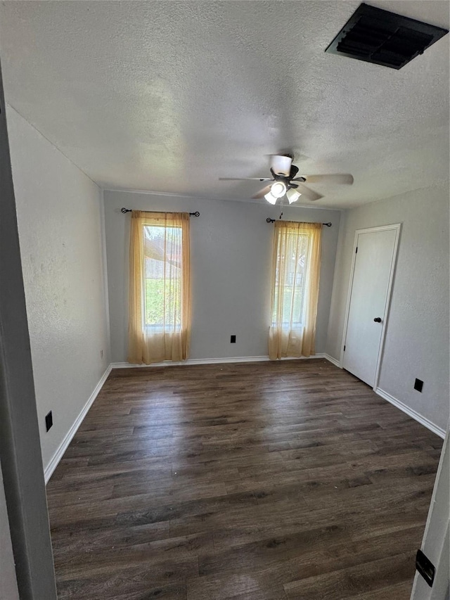 3401 89th St, Lubbock, TX 79423 - unfurnished room with dark wood-style flooring, a ceiling fan, and a textured ceiling
