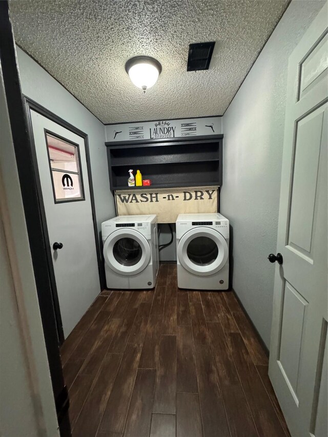 3401 89th St, Lubbock, TX 79423 - laundry area featuring dark wood-style flooring, washing machine and dryer, and a textured ceiling