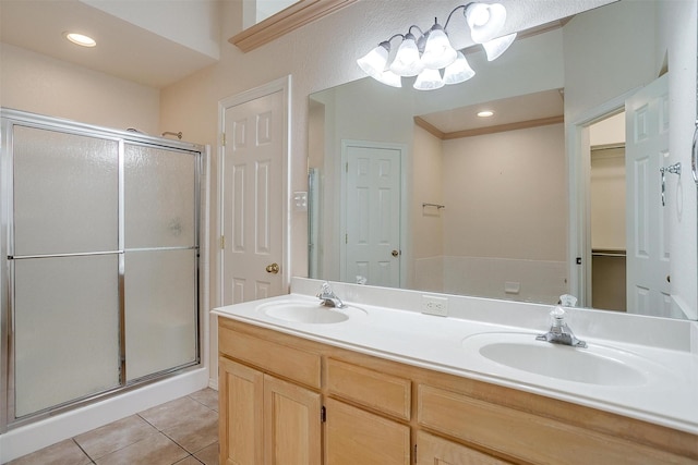 bathroom with a shower stall, tile patterned floors, and a sink
