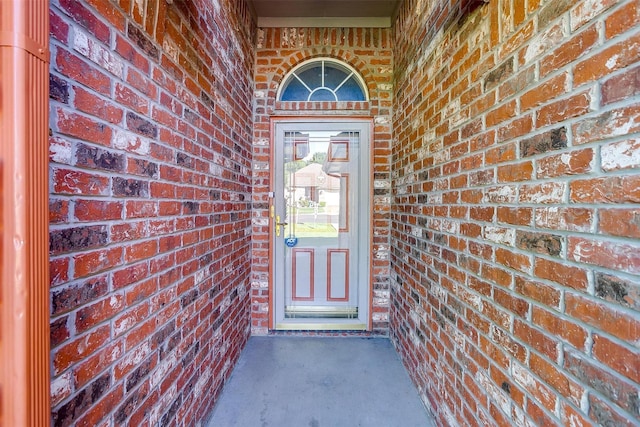 entrance to property with brick siding