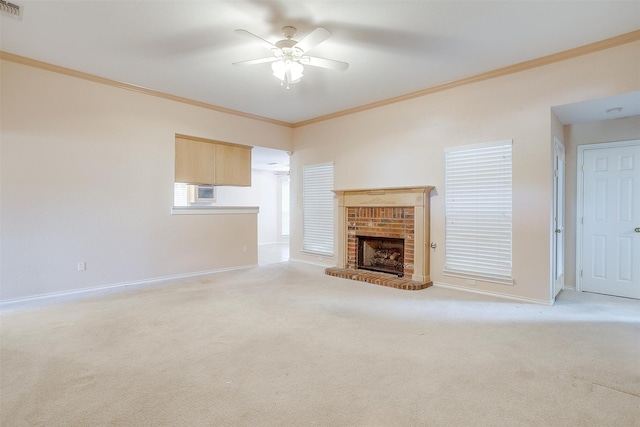 unfurnished living room with a ceiling fan, baseboards, crown molding, and carpet floors