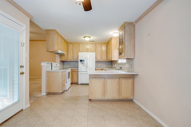 kitchen with a peninsula, light countertops, white appliances, and light brown cabinetry