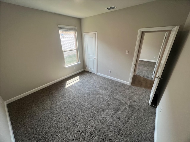 unfurnished bedroom featuring baseboards, visible vents, and carpet floors