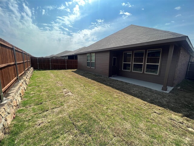 exterior space featuring a fenced backyard and a patio