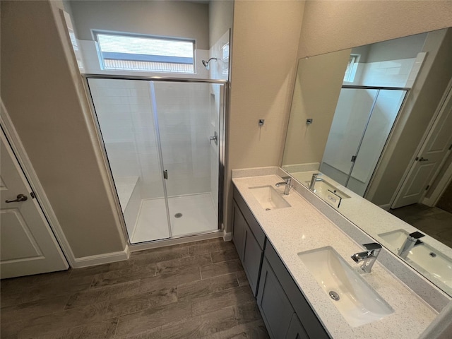 full bathroom with wood tiled floor, a stall shower, and a sink
