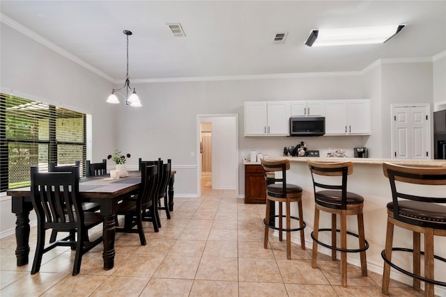 dining room with a notable chandelier, visible vents, ornamental molding, and light tile patterned floors