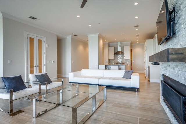 living room with visible vents, crown molding, and wine cooler