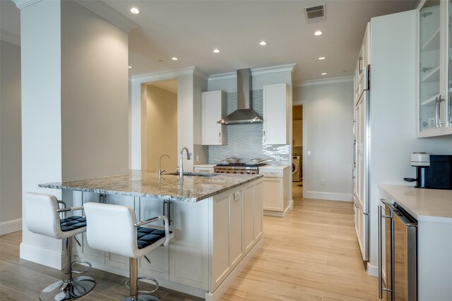 kitchen with stainless steel microwave, light countertops, visible vents, and backsplash