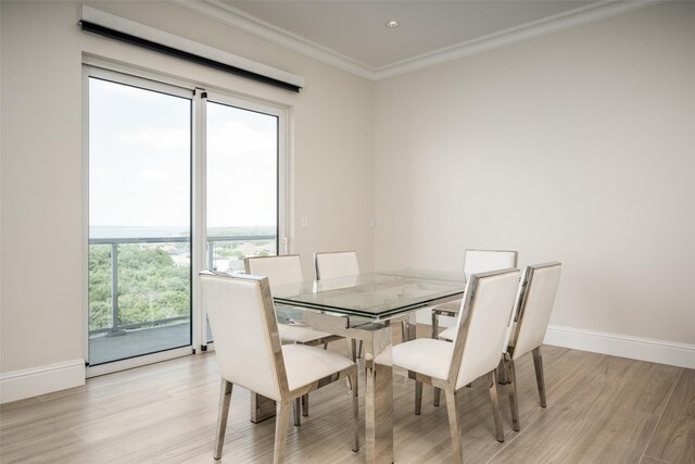 dining space with a ceiling fan, light wood-style floors, a fireplace, ornamental molding, and visible vents