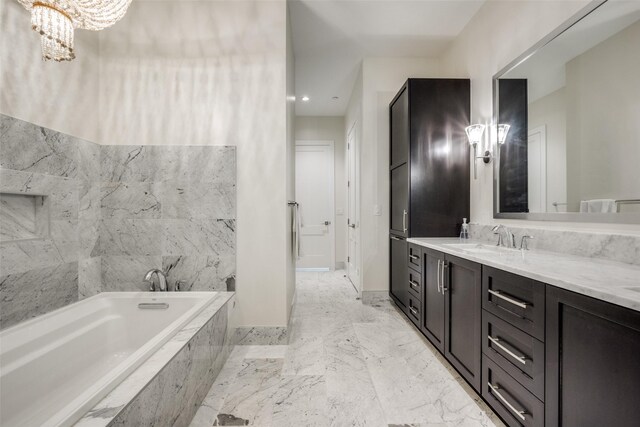 full bathroom featuring an inviting chandelier, double vanity, visible vents, a washtub, and a sink