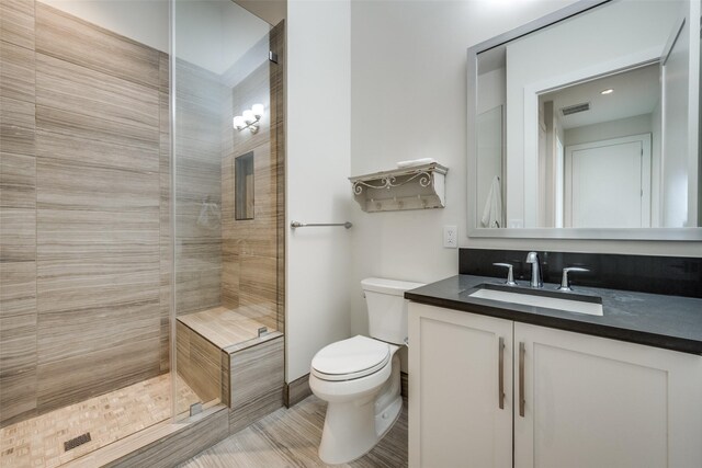 bedroom with baseboards, visible vents, wood finished floors, ceiling fan, and ornamental molding