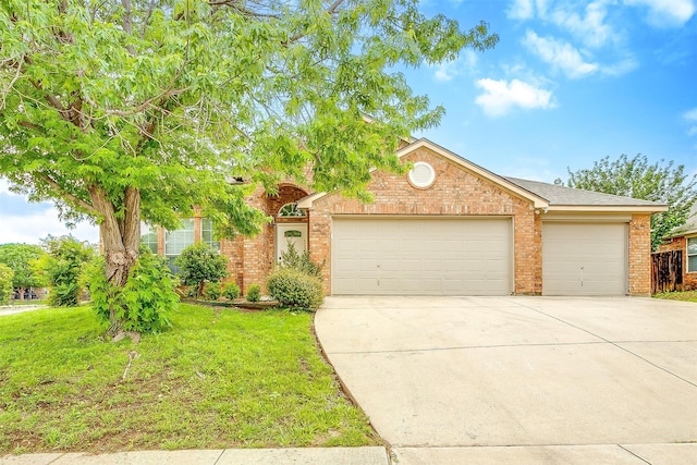 view of front facade featuring concrete driveway, brick siding, an attached garage, and a front lawn