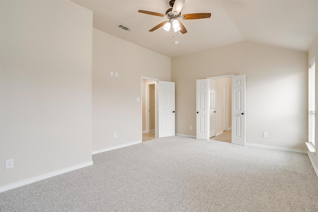 unfurnished bedroom with ceiling fan, light colored carpet, visible vents, baseboards, and vaulted ceiling