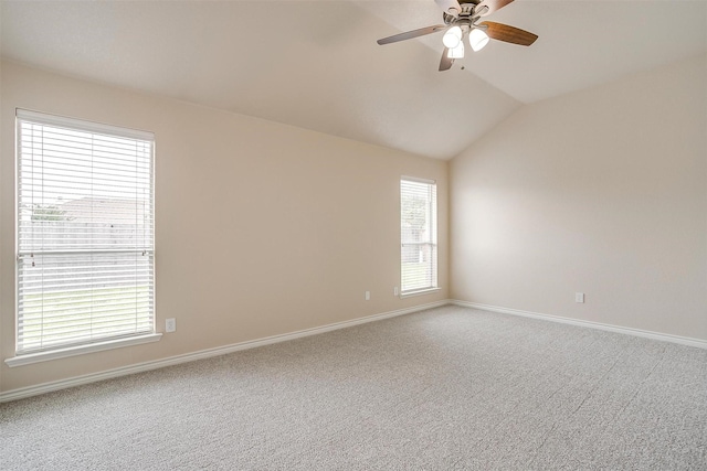 spare room with carpet floors, a ceiling fan, and baseboards